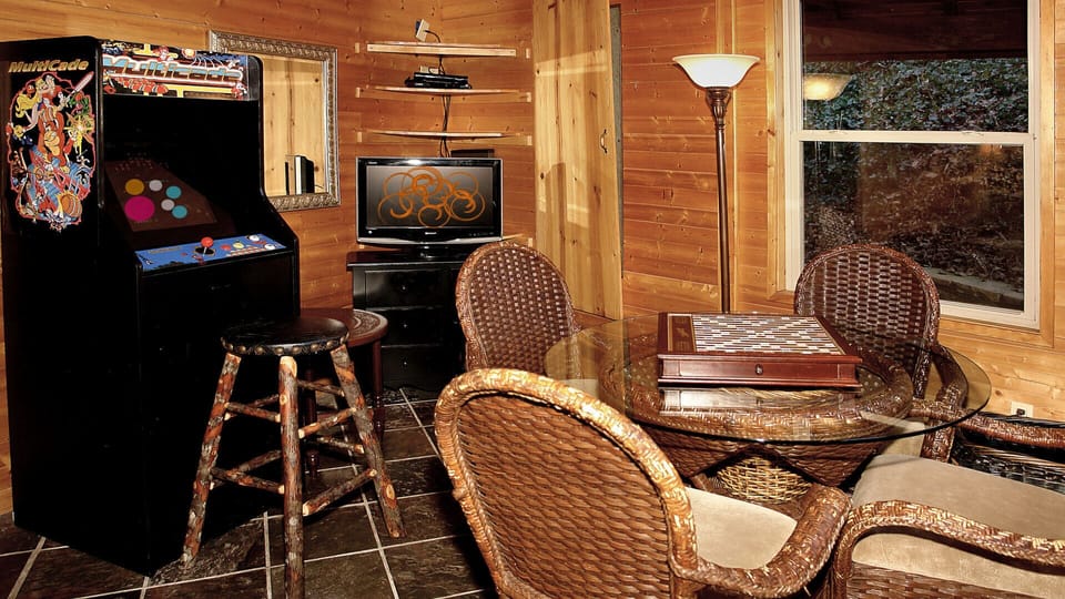 Sunroom with arcade game, TV, and table