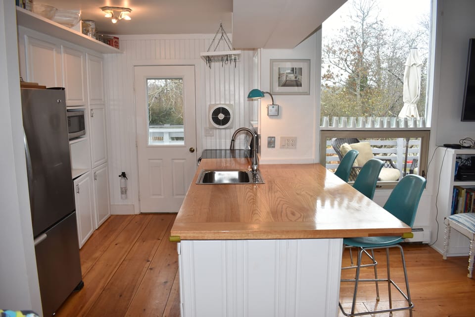 Kitchen exits to upper level deck.