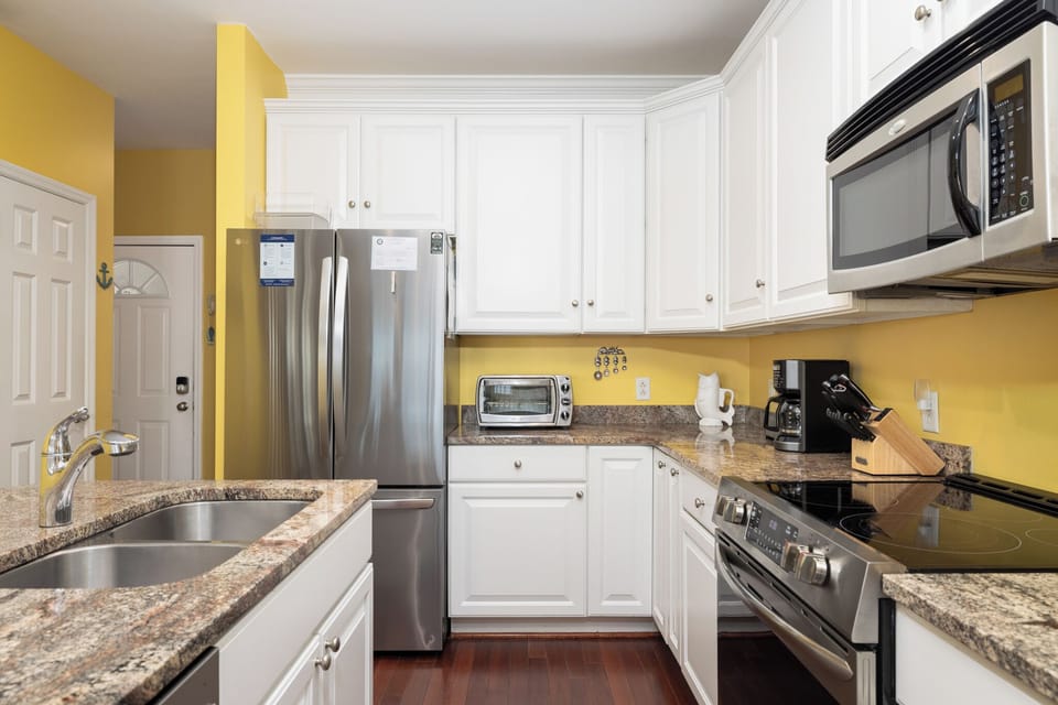 Your fully-equipped kitchen features granite countertops and stainless steel appliances