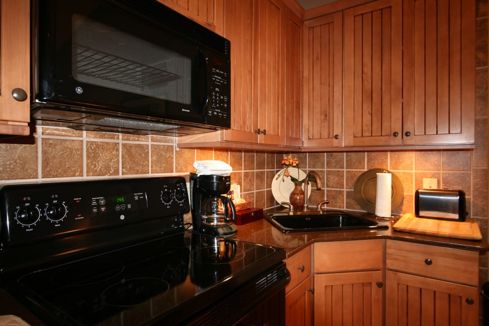 Fully equipped hardwood and granite kitchen area