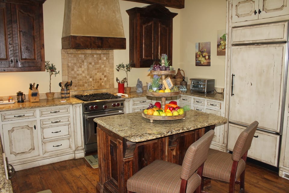 Kitchen granite countertops, real wood floor, Wolf gas range, Sub Zero refrig