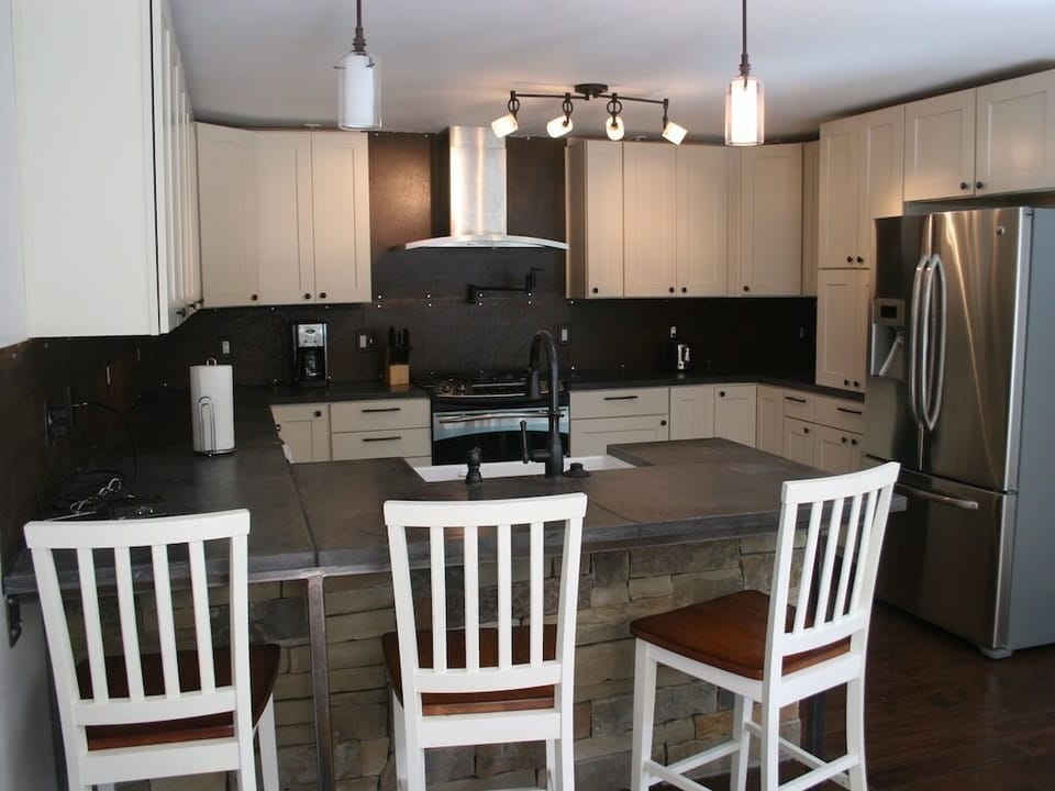 Gourmet kitchen - custom cabinets, concrete counters & stainless appliances- 