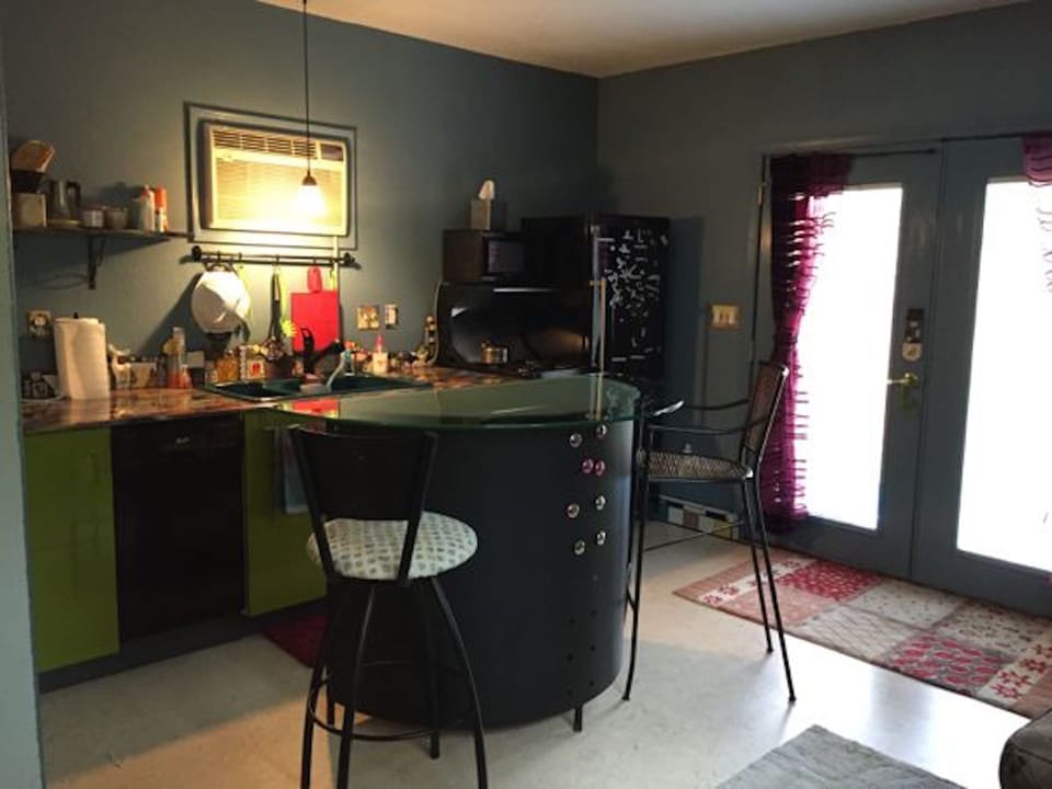 View of kitchenarea; d/w, large frig, 4-burner stove