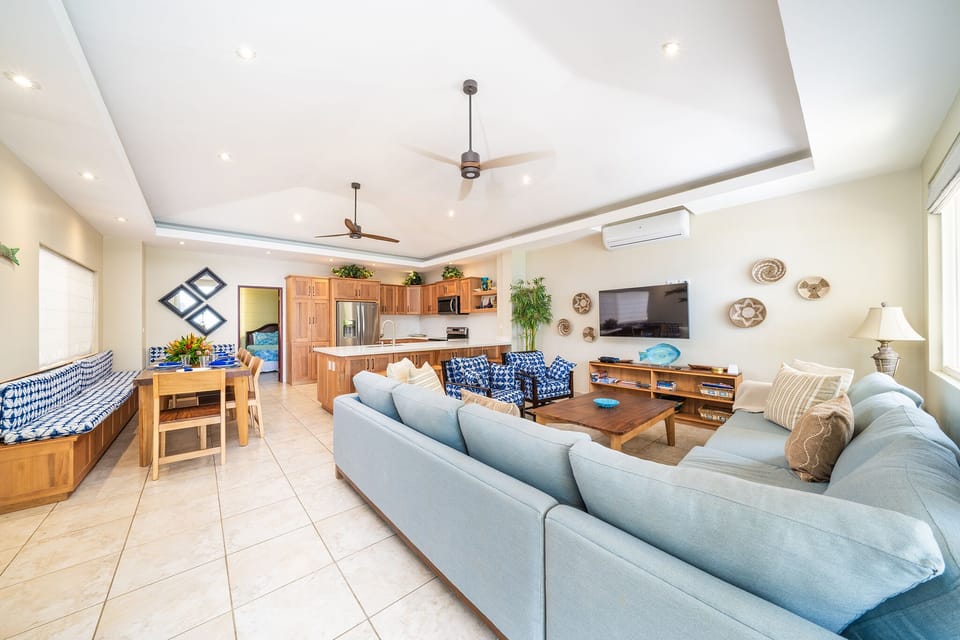 Spacious and airy great room includes kitchen, dining and living spaces.