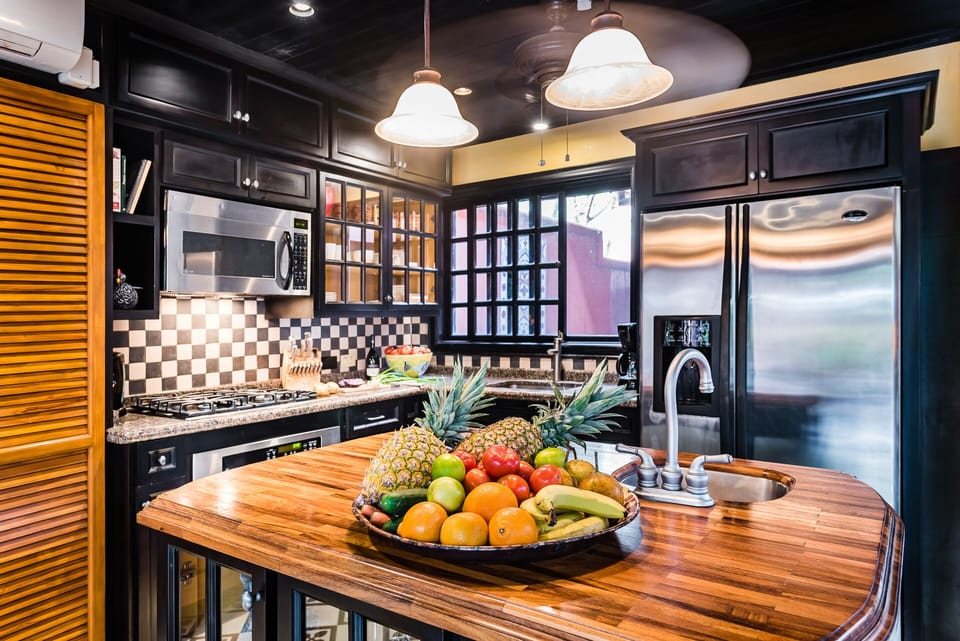 The kitchen is fully equipped with modern stainless steel appliances
