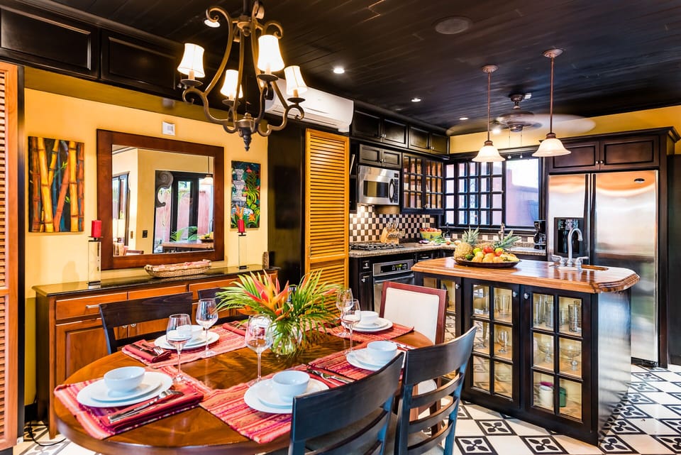 The Dining Room and Kitchen are separated by a wet bar and curio/island