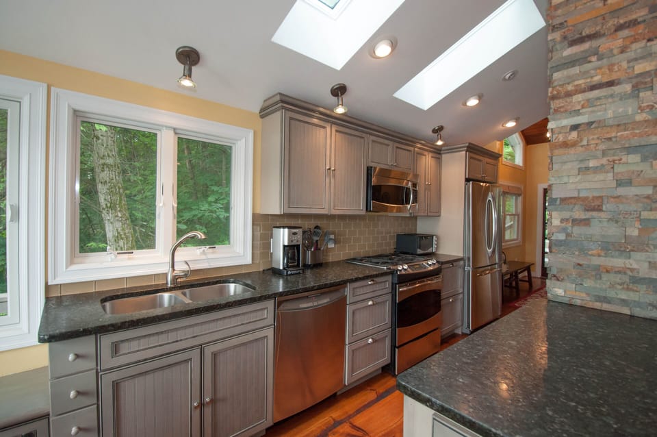 Kitchen with full size appliances, coffee maker, plates and pots and pans.