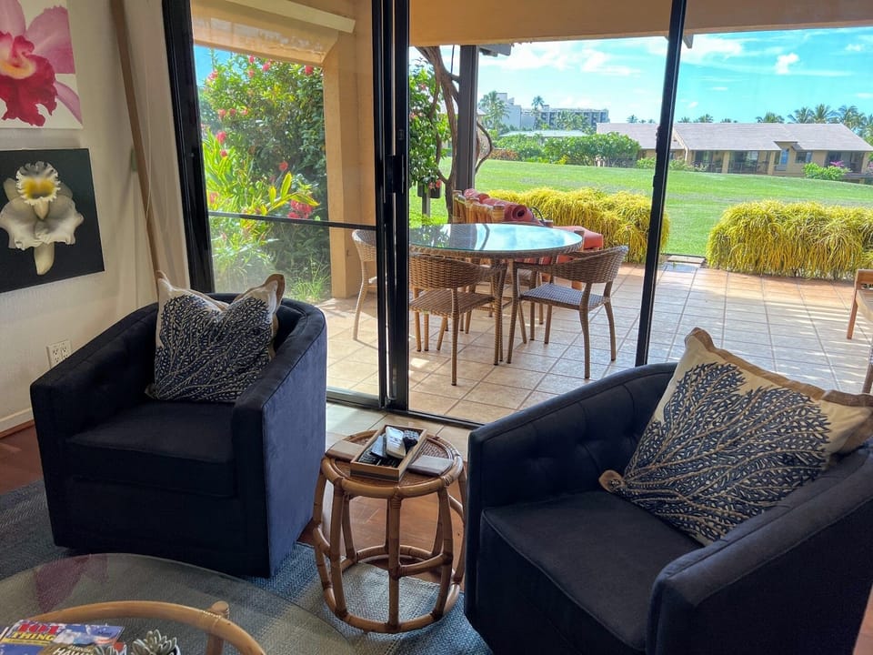 View from living room to lanai and view. Chairs swivel for view or chatting.