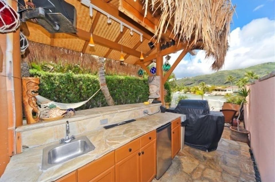 Tiki bar with tv, stereo, BBQ, firepit, outdoor lighting, hammock,and tiki's