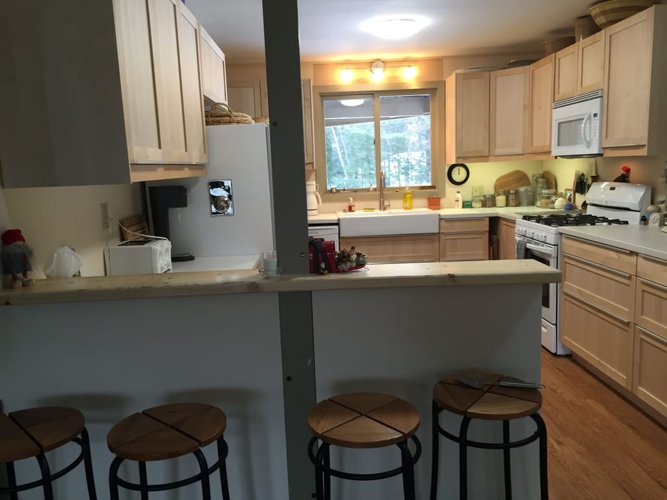 Fully-furnished kitchen: gas stove, microwave, refrigerator, dishwasher.