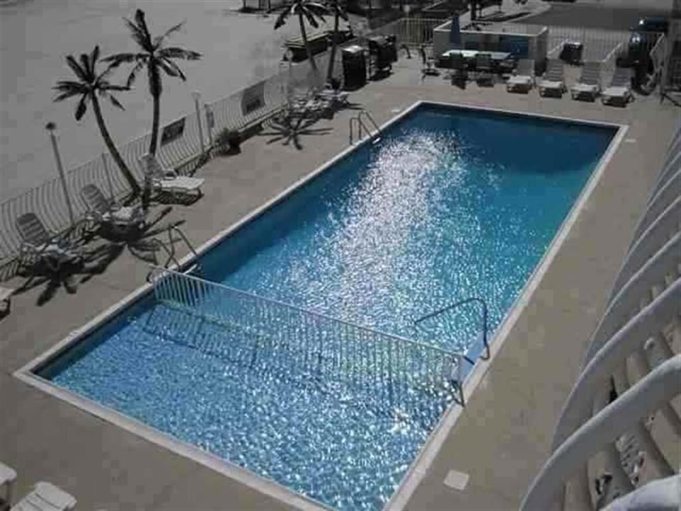 heated pool with kiddie pool attached. Walk off the pool deck to the sand.