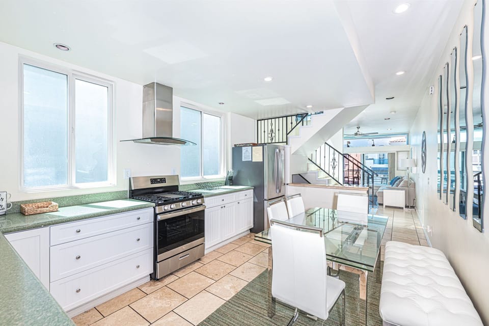 The cook's view toward the dining, living and ocean view balcony areas. Main middle level.
                
