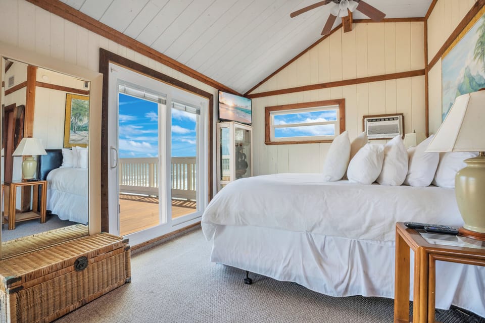 Master bedroom takes entire second level with two patios and king size bed.