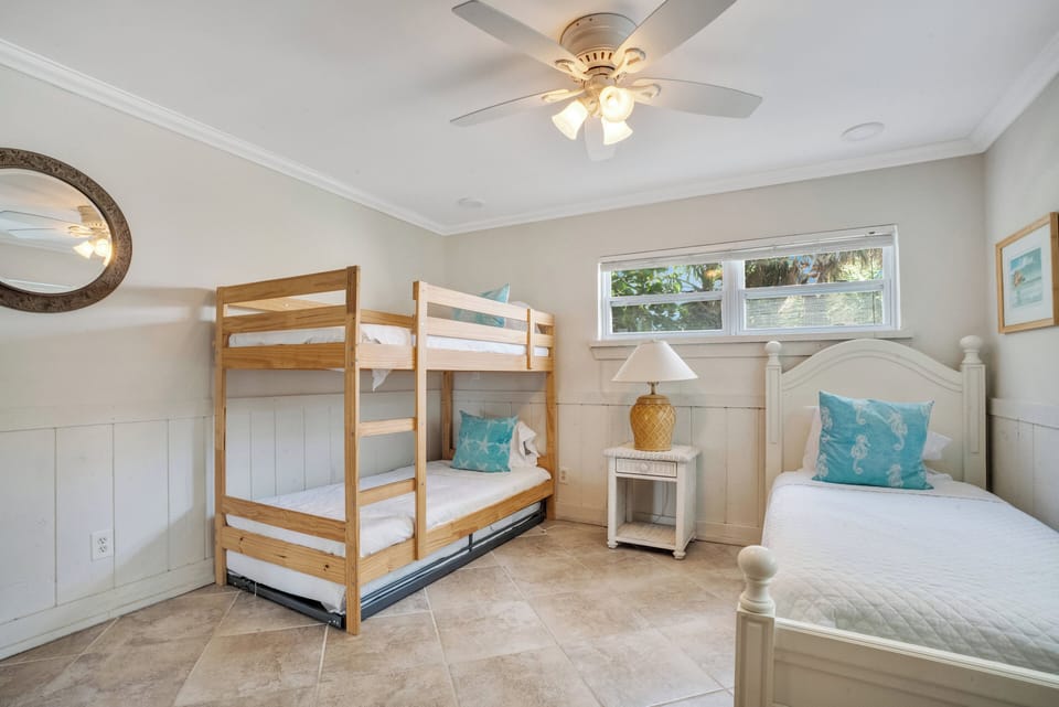 Third bedroom with single, bunk bed, and trundle bed and tv.  Sleeps 4.