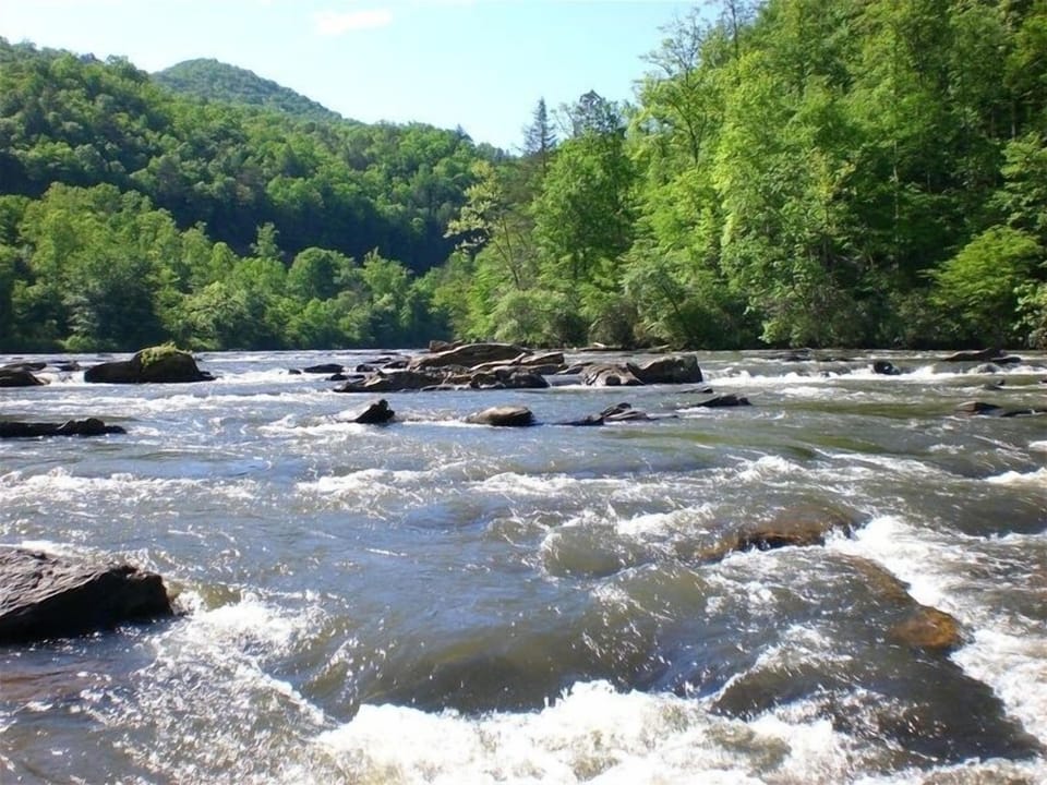 The Little Tennessee River flows gently by near the home......a short walk away.