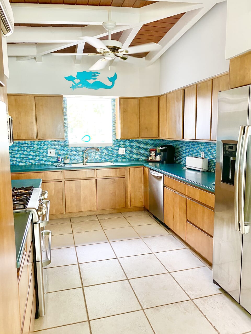 Glass backsplash and nautical touches adda special feel to the kitchen. 
