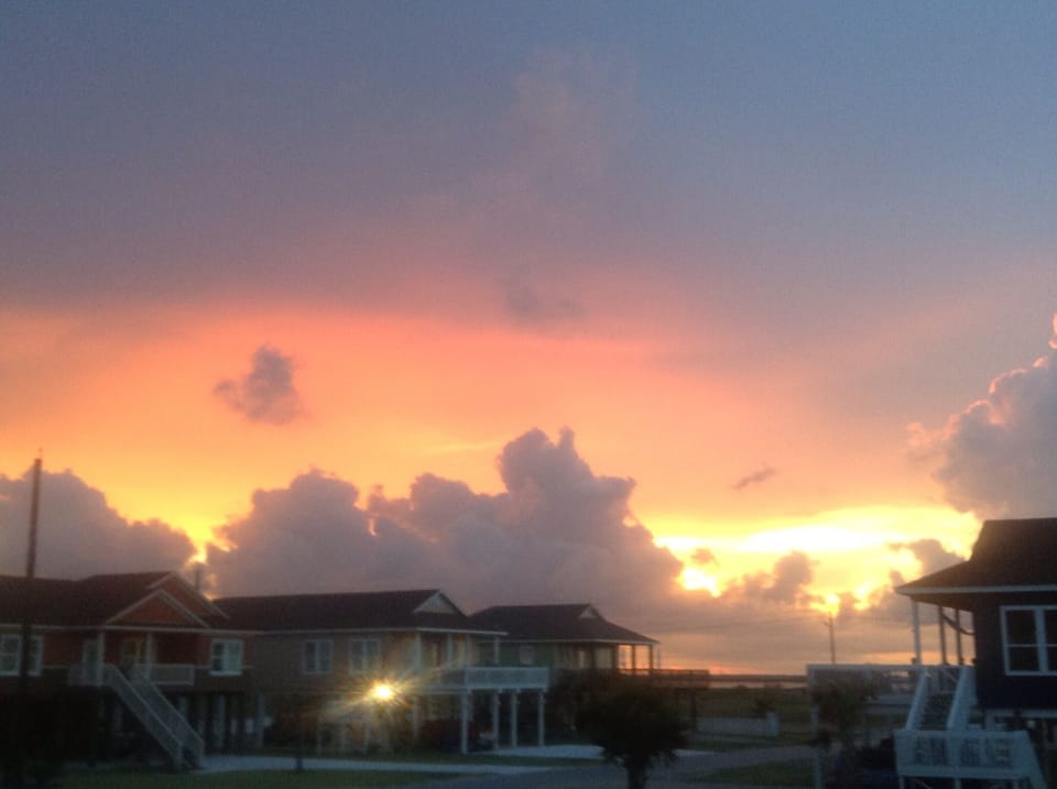 View of Sunset over the bay and the quiet cul-de-sac street neighborhood. 