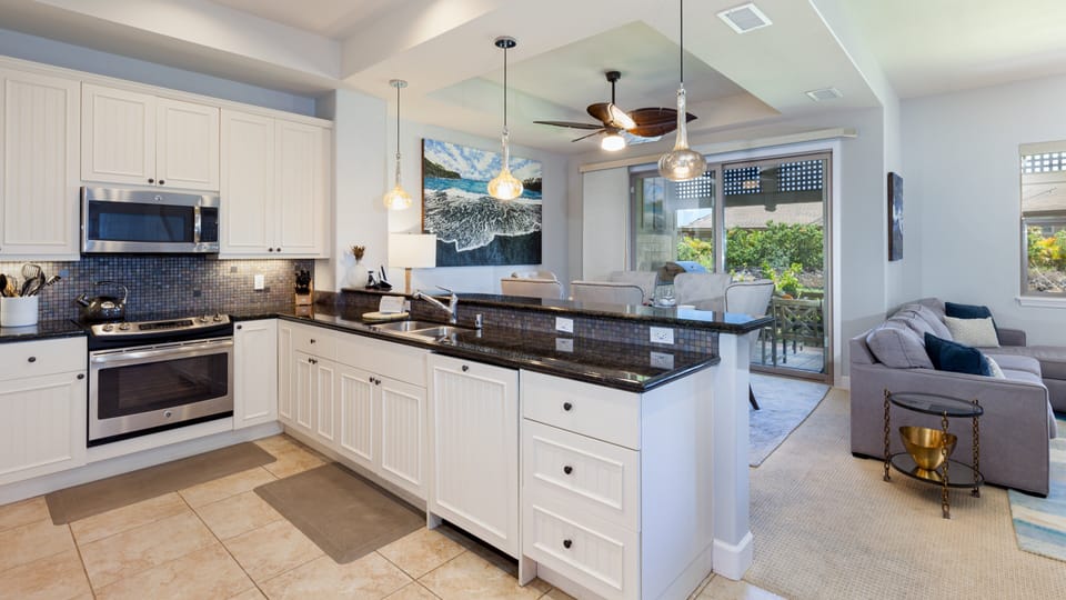Open concept kitchen with a great assortment of oils, spices and essentials provided