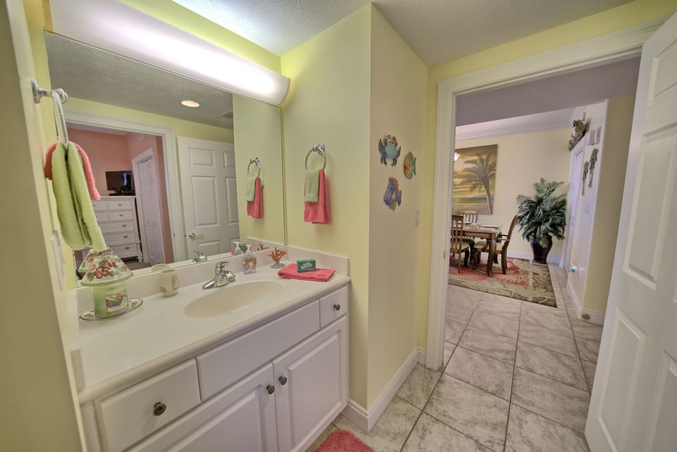 FROM GUEST BEDROOM INTO GUEST BATH. ALSO LOOKING INTO DINING AREA