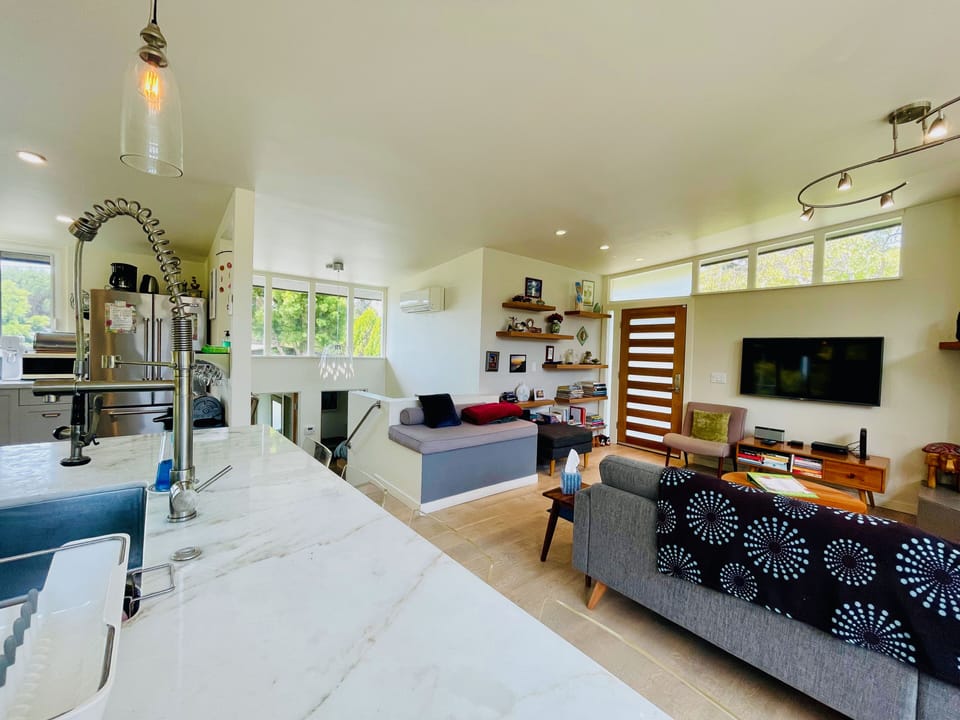 Living room, entryway, and stairwell from kitchen island