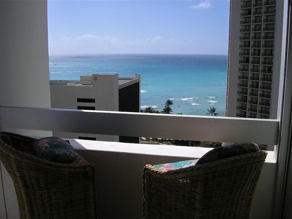 This spacious balcony has a great ocean view with furniture for outdoor dining.