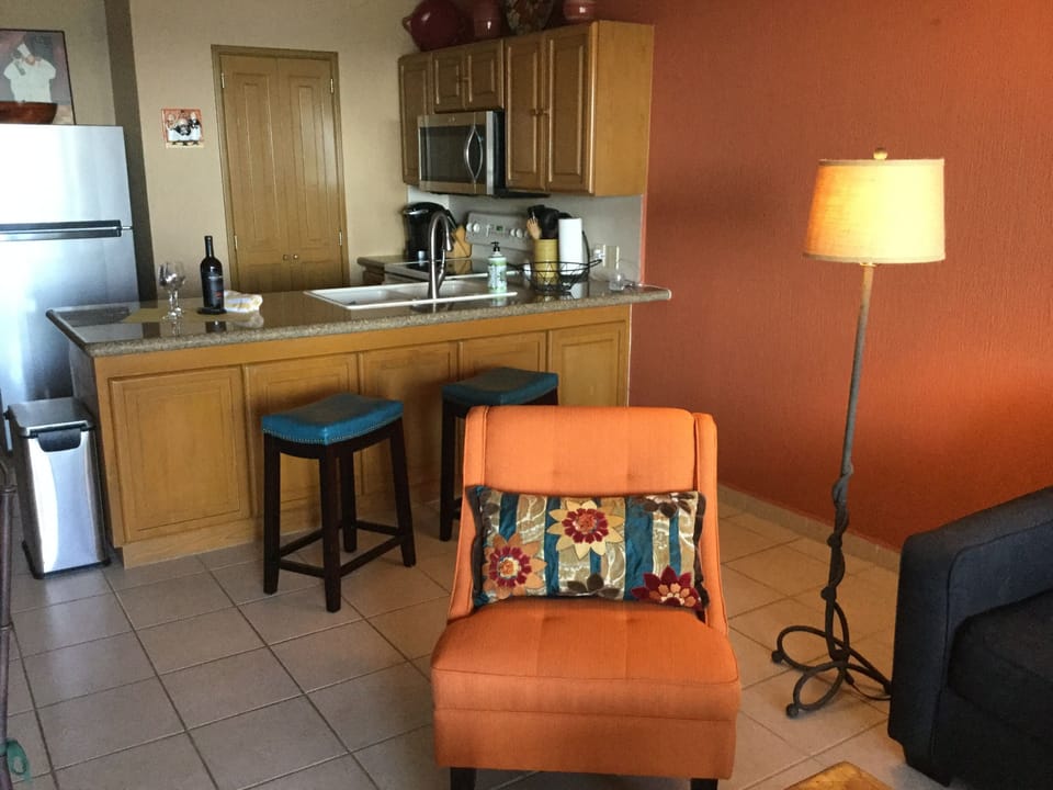 Kitchen with  granite counter/ barstools.