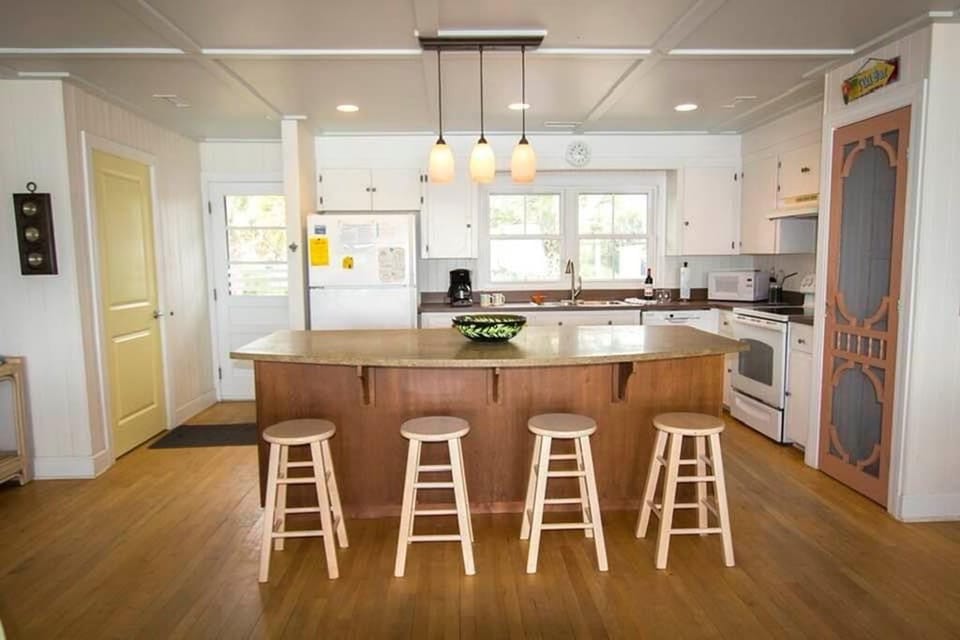 Bright and open kitchen. Island seats 4. Full size screen door pantry. 