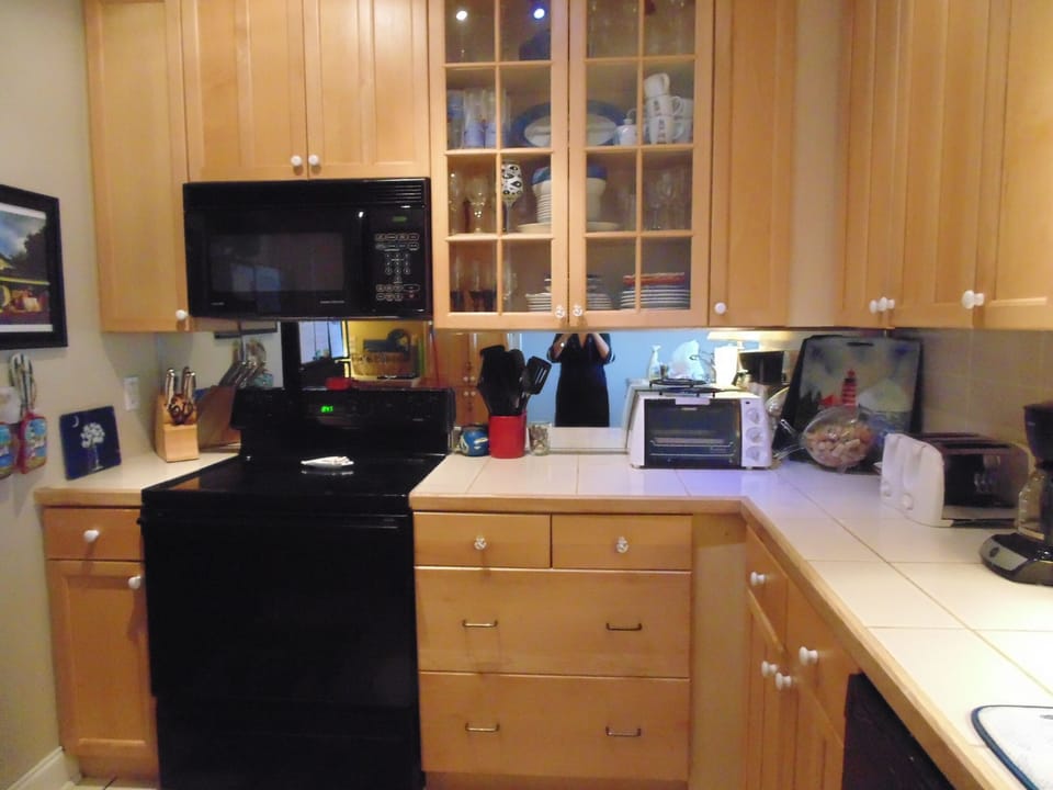 Kitchen.  Well stocked with cookware and dishes.