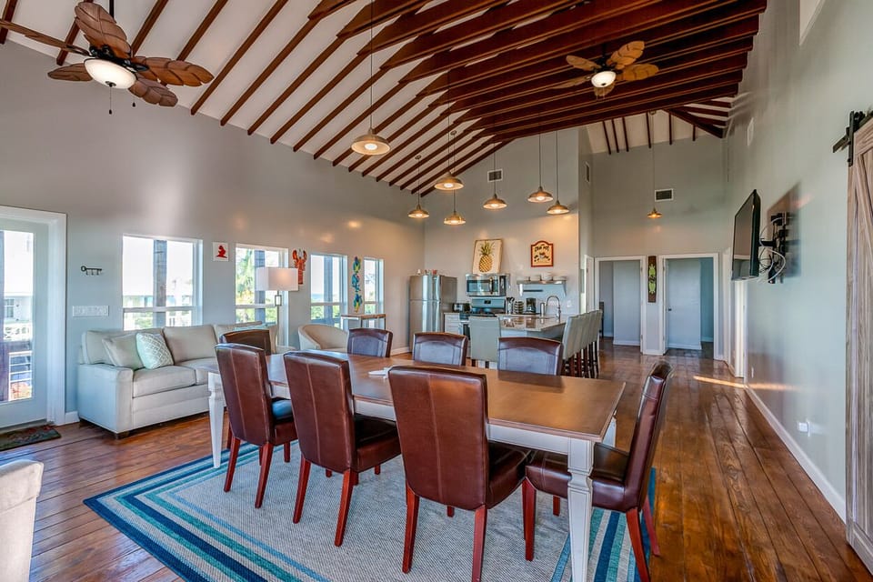 Dining table and sitting area with television.