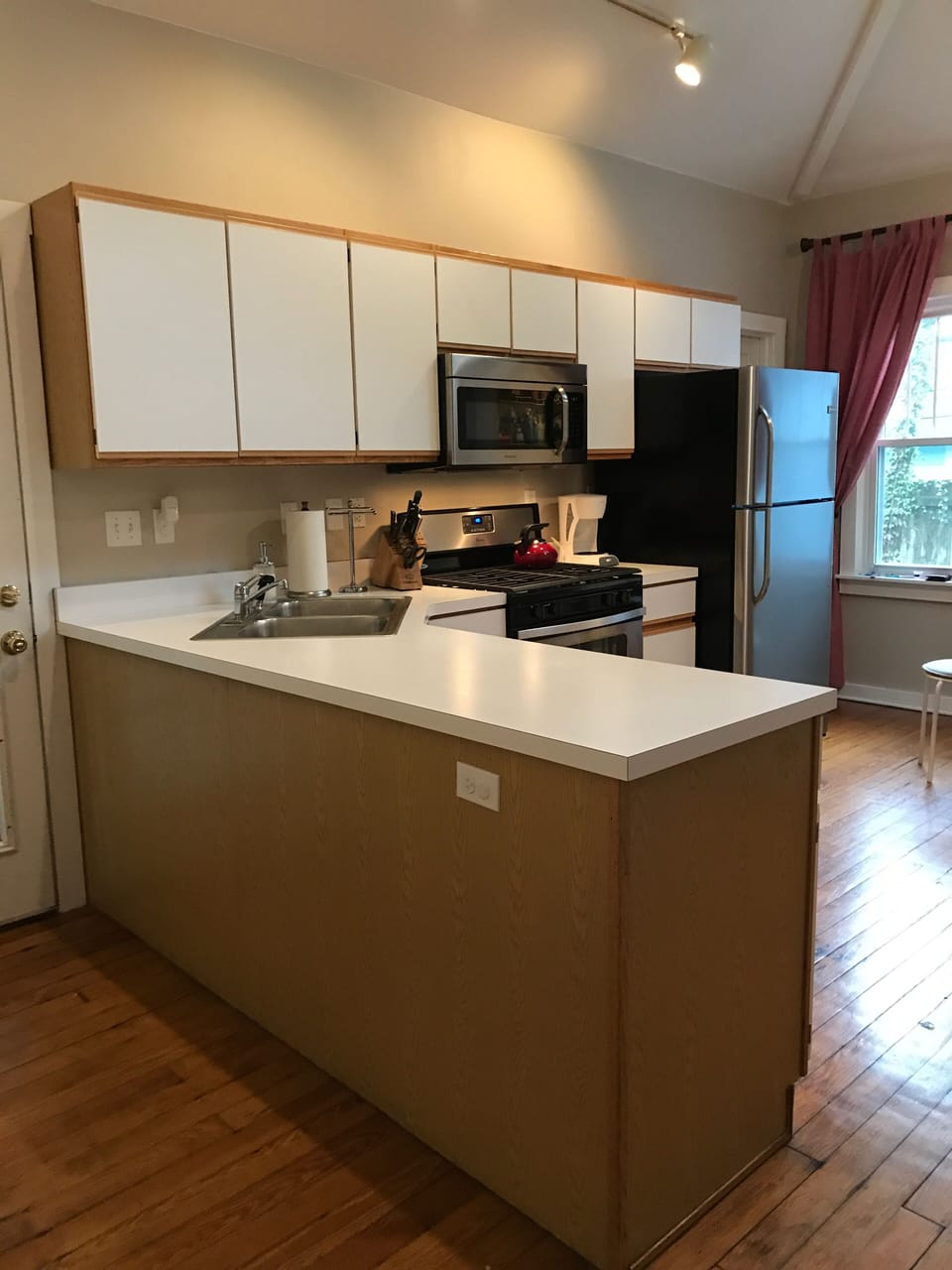 Large, vaulted ceiling kitchen with skylight and plenty of windows.