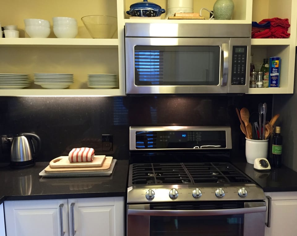 double range, dishwasher and quartz counters in kitchen