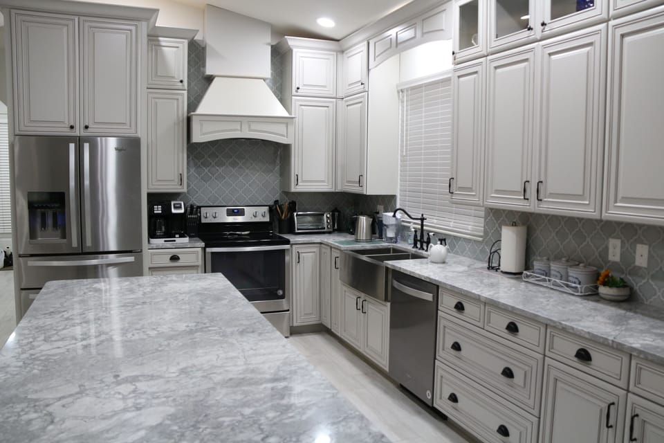 Elegant French-style kitchen with sleek countertops and classic cabinetry.