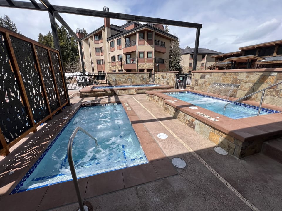 New, spacious hot tubs with water features with views of the slopes