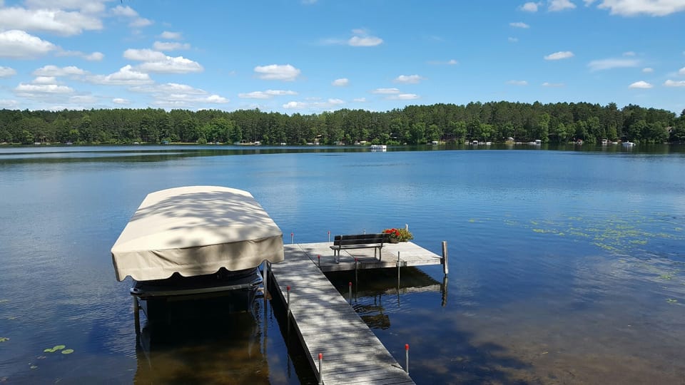Clear water with sandy bottom, great for swimming and fishing off the dock!
