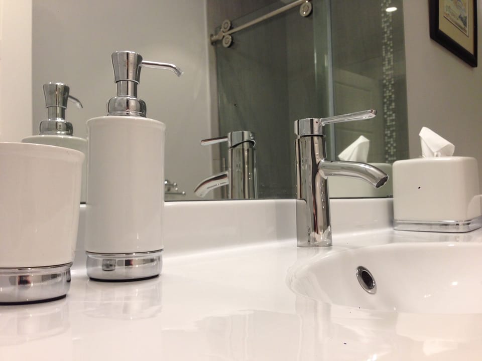 Modern bathroom with double shower (no tub) and essential items, incl hair dryer