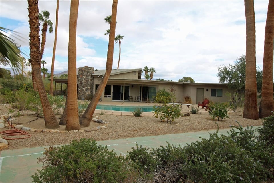 Looking at the rear of our house with pool and shuffleboard court