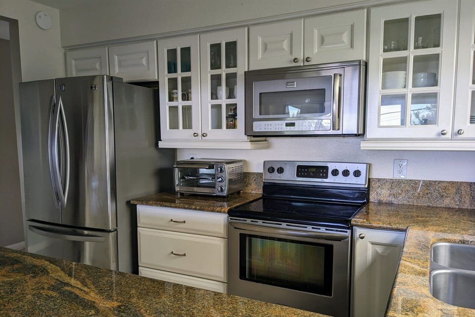 Updated kitchen is fully stocked and opens up to the main living area
