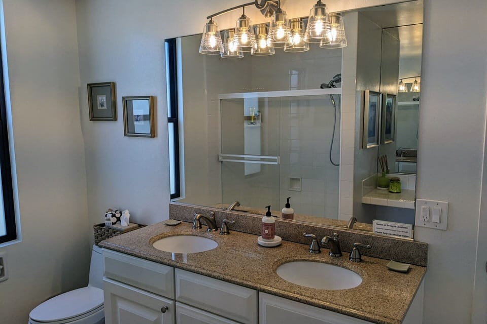 Primary bathroom features dual vanities
