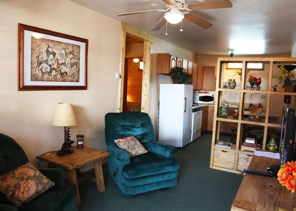 Living Area Foreground; kitchen in background.  Newly painted. 32 in flat screen