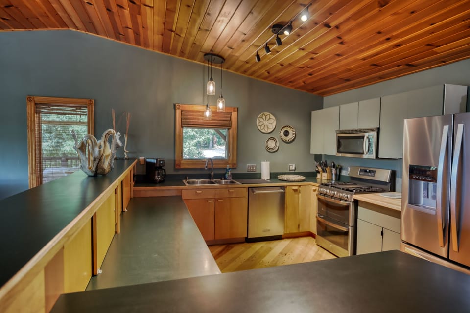 Fully equipped kitchen with utensils and spices.