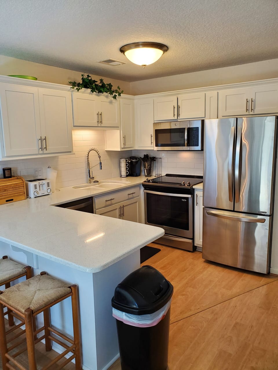 New kitchen with convection, oven, cooktop, dishwasher, silestone bar and chairs