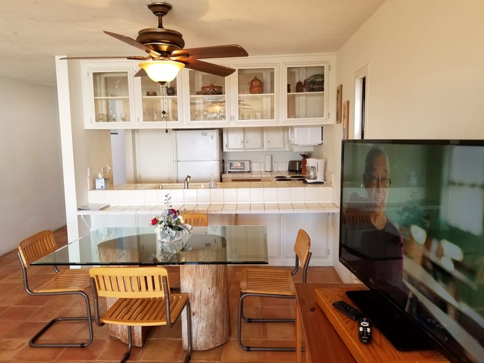 Standing in front of living room furnishings looking  to the kitchen