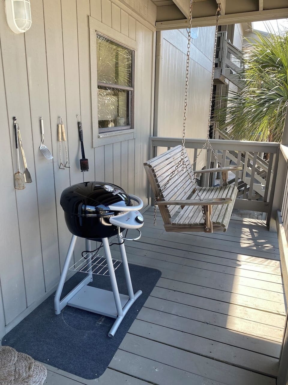 North Deck off dining area with electric grill, swing and chairs