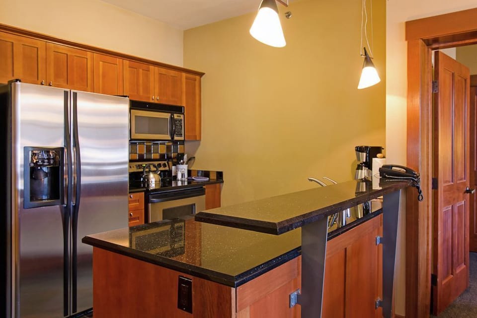 Enjoy a fully stocked kitchen featuring sleek stainless steel appliances, perfect for preparing meals with ease