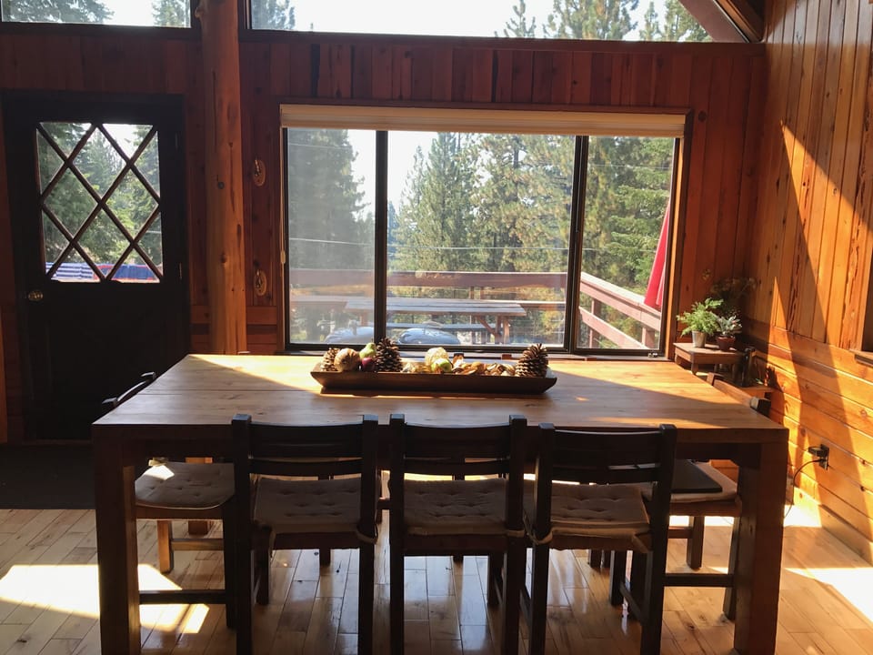 Handmade dining table which looks onto deck