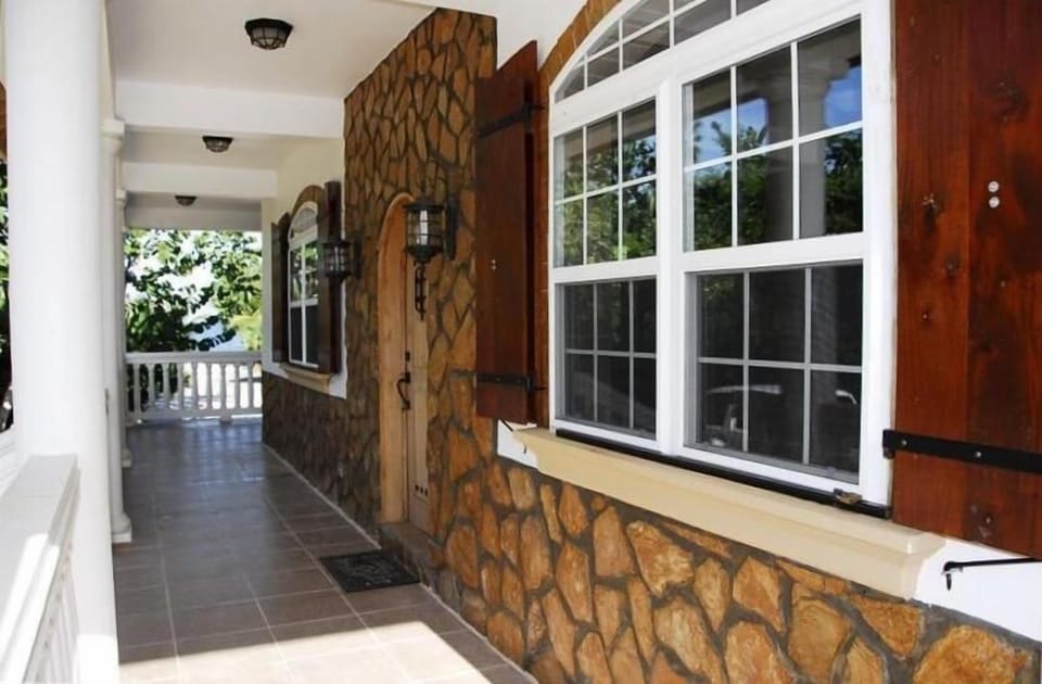 A new custom built beach house with hand cut stone trim and mahogany shutters.