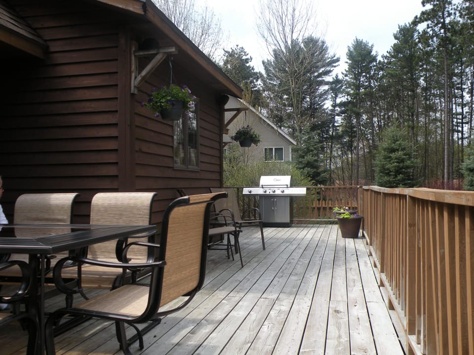 Deck overlooks the pool and has plenty of seating and a gas grill.
