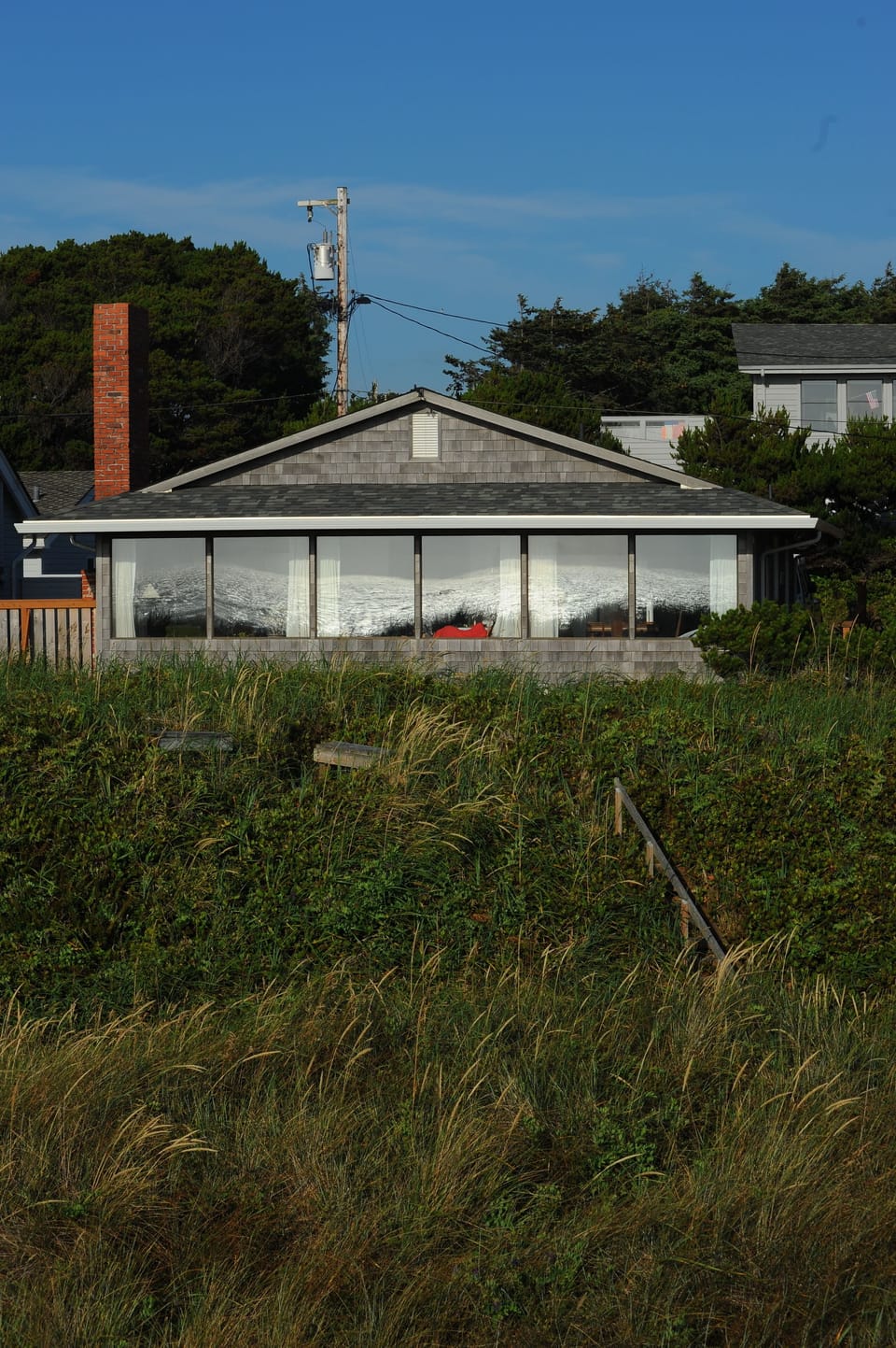 Ocean reflected in the wall of glass.