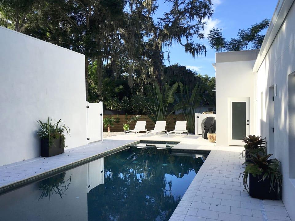 Saltwater pool and hot tub, outdoor shower, lounge area and gas grill.
