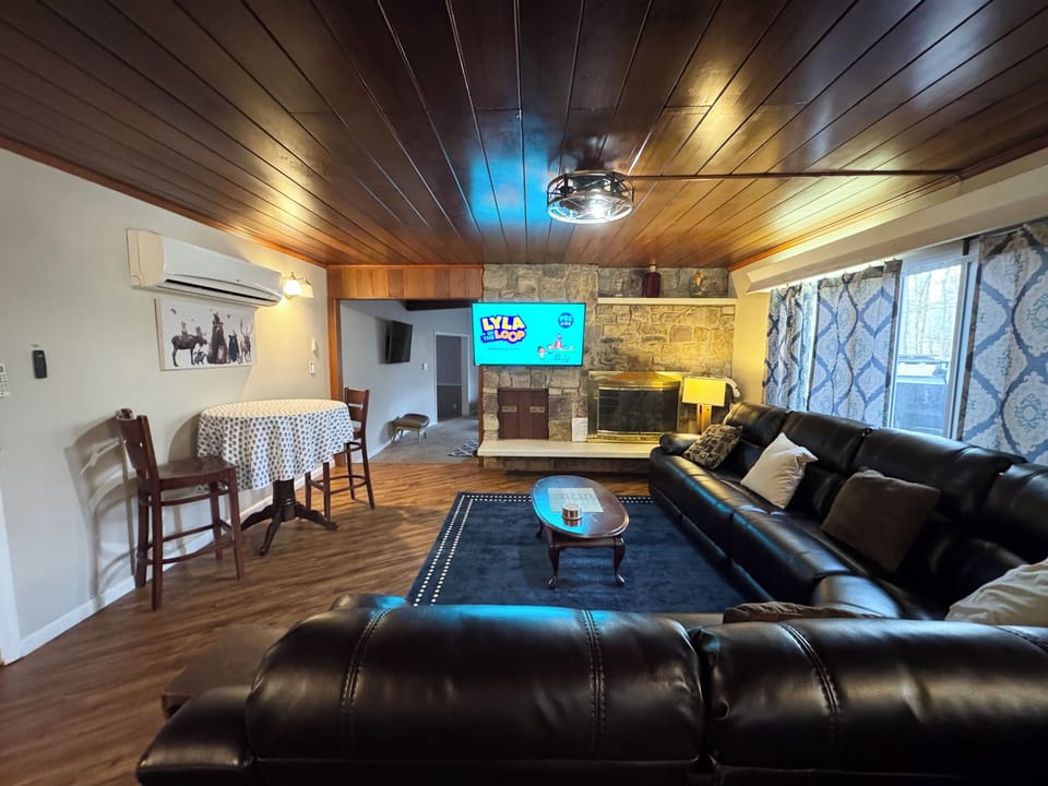 Main room view from kitchen area with view to fireplace and tv 